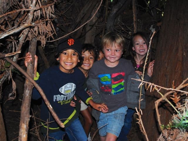 Five kids hiking through the woods