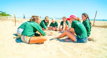 Campers building a fire pit on the beach