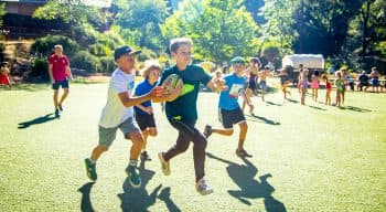 Boys playing rugby at camp