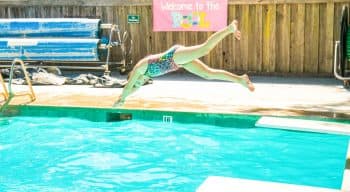 Camper dives into pool at summer camp