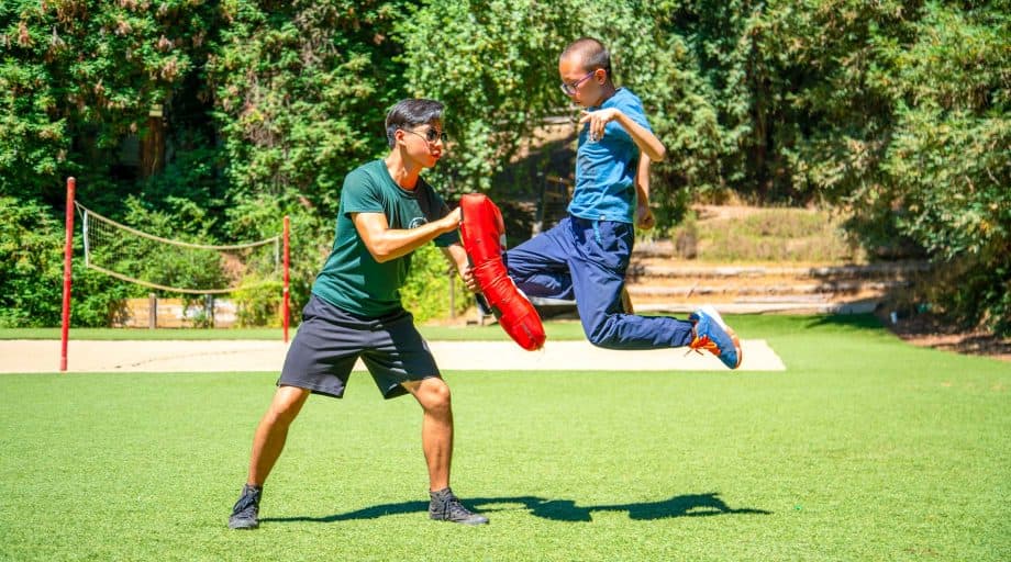 Camper mid-jump during martial arts practice