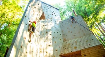 Two campers climbing a rock wall