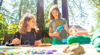 Girls do arts and crafts at summer camp