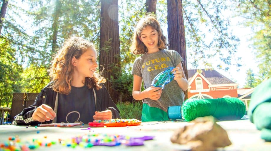 Girls do arts and crafts at summer camp