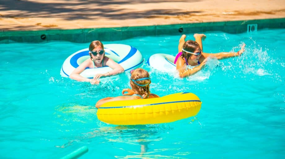 Campers lounge on inner tubes in pool