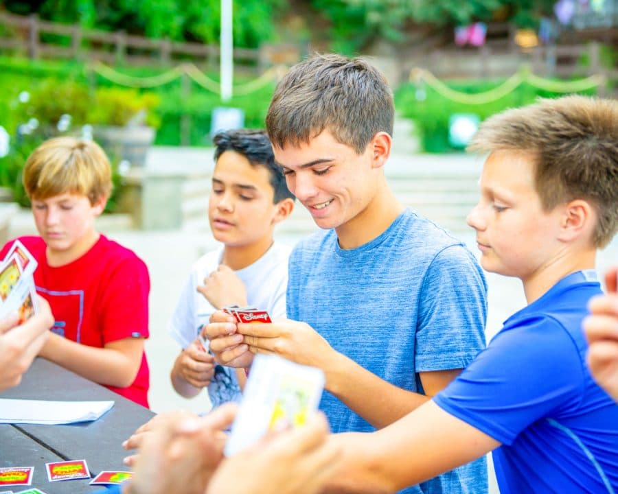 Group of boys play Uno at summer camp