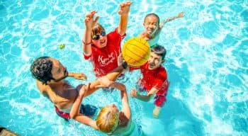 Campers play ball game in the pool