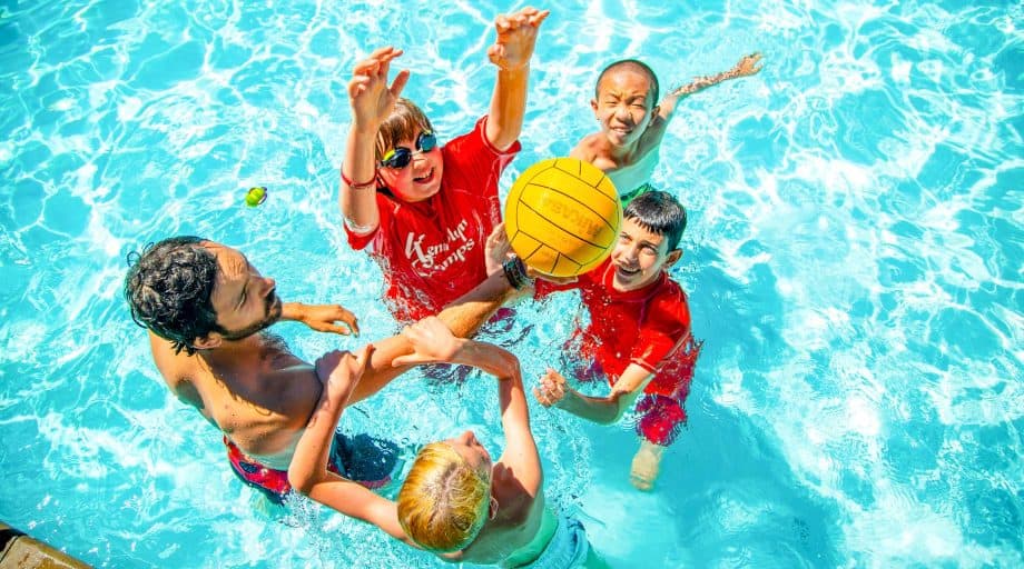 Campers play ball game in the pool