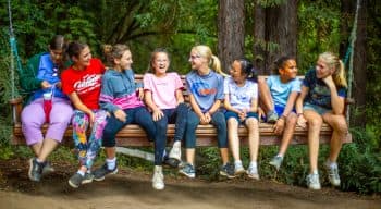 Campers on a swing laughing