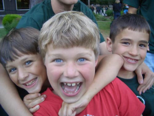 Three boys smiling for a selfie