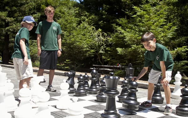 Campers play with a life size chess board