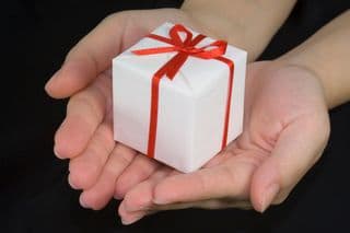 Hands holding a tiny wrapped present