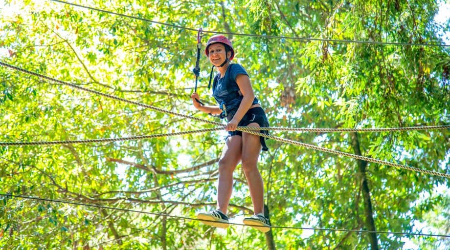 Girl smiles from high ropes course