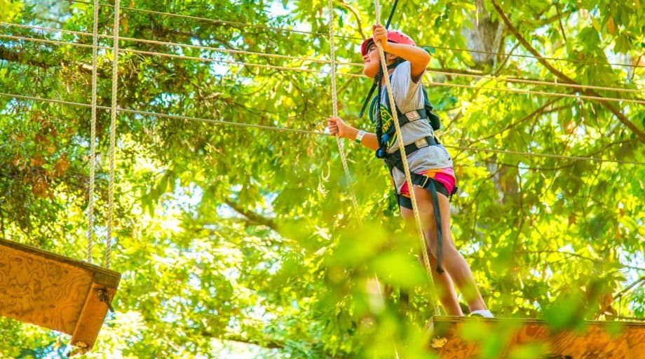 A girl walking the plank on the ropes course