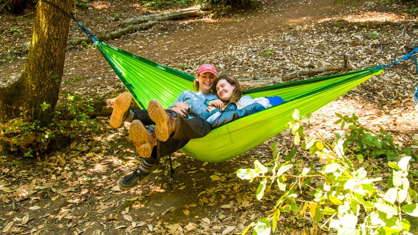 Girls lounging in hammock at summer camp