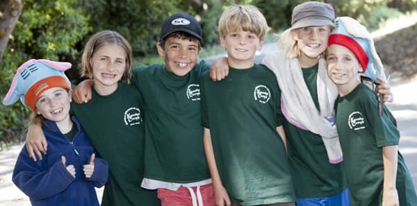 A group of campers with funny hats pose for a photo