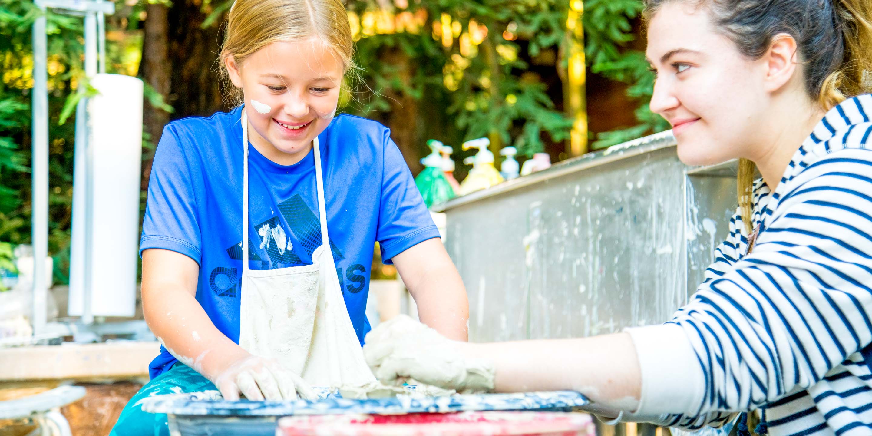 Girl does pottery at summer camp