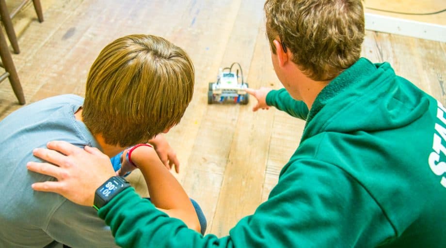 Counselor and camper watch robot drive