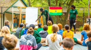 Counselors showing campers where Ghana is