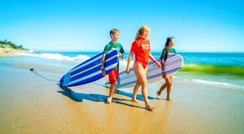 Campers walking with surfboards