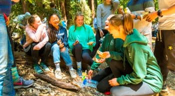 A group of campers hiking and laughing