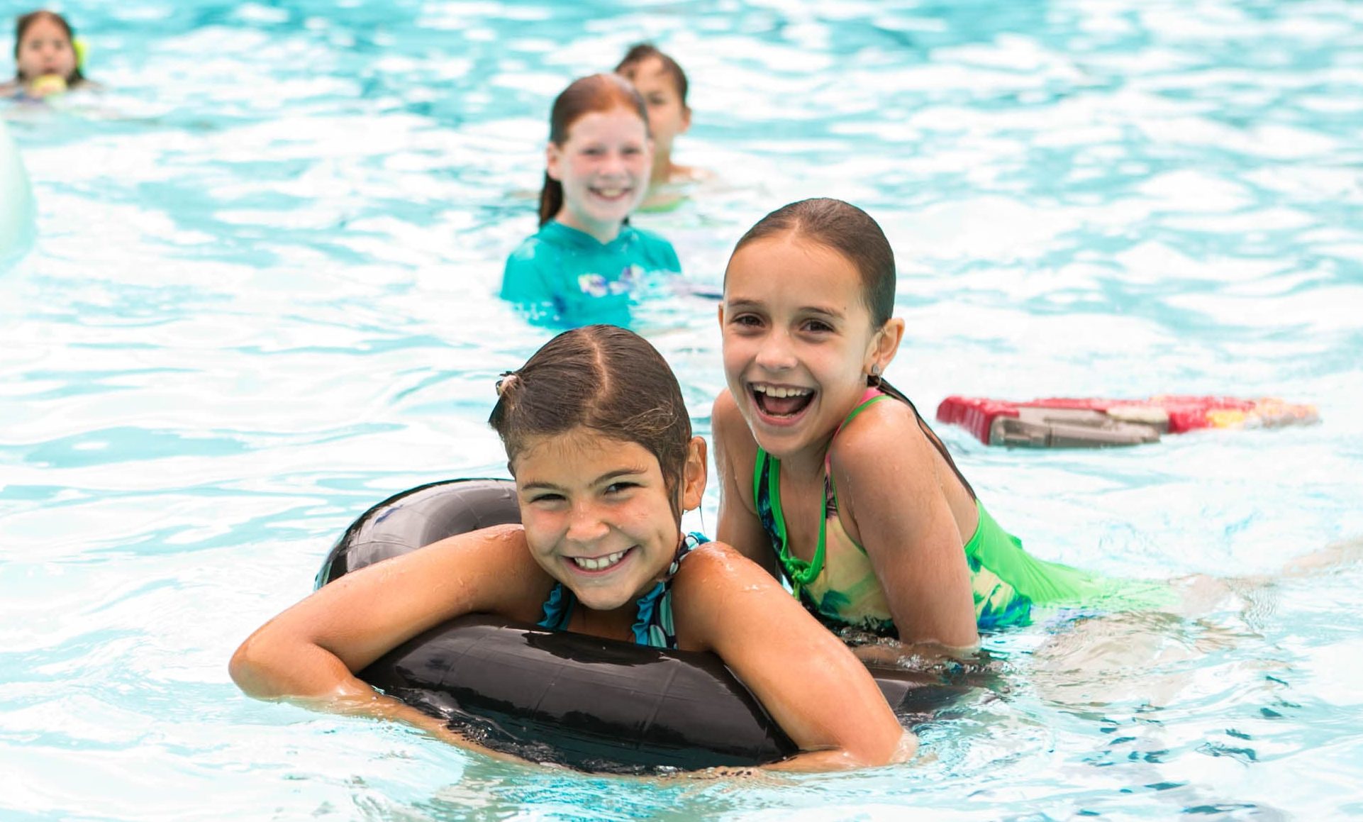 Kennolyn day campers laugh while swimming
