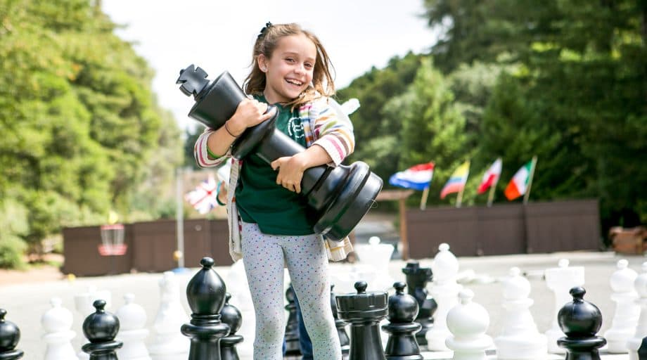 Day camper holds giant chess piece