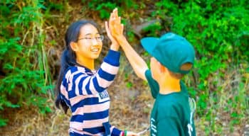 Two campers high-fiving