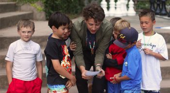 A counselor reading a clue to campers