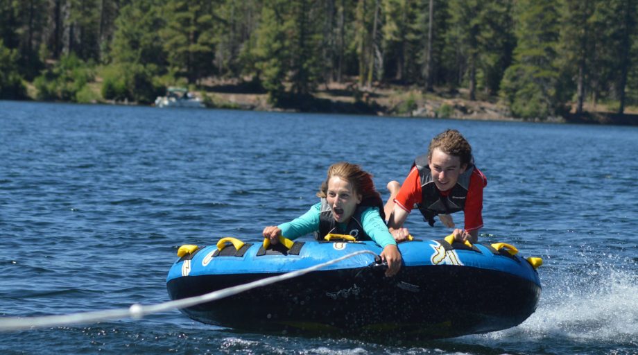 Boys on a tube in the water