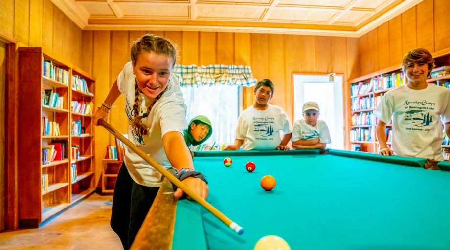 a girl aiming in pool