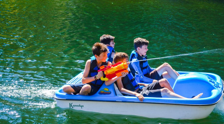 four boys on a paddle boat