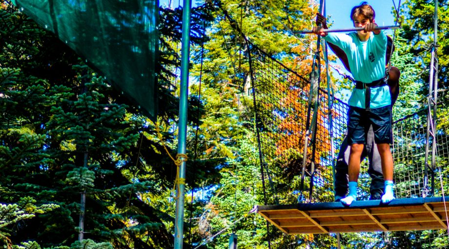 a boy getting ready to jump on a trapeze
