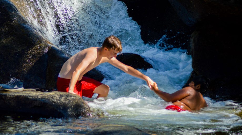 Boys goofing off in a waterfall