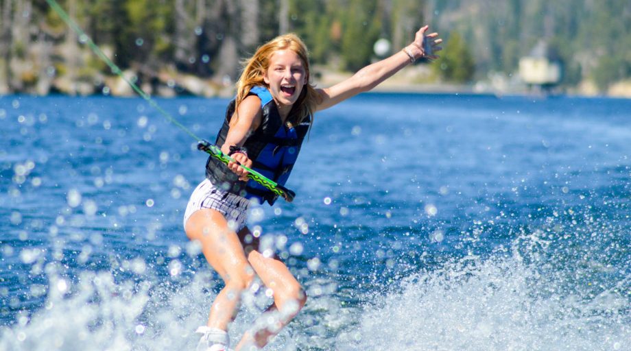 A girl trying a trick on water skis